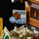Detailed 'SKI LODGE GUESTHOUSE' sign and snow greebling.