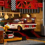 Car lift in illuminated service bay.