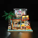 Front view of the illuminated surf shop at night.