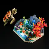 Modular turtle and illuminated reef on black background.