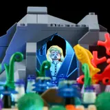 Minifigure silhouette backlit in blue cave.