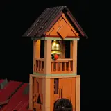 Illuminated bell tower apex with gold bell.
