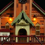 Close-up of illuminated entrance arch and sign.