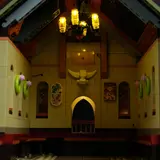 Illuminated interior with chandelier and bull skull.