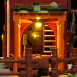 Close-up of illuminated stable archway at night.