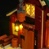 Close-up of illuminated barn door and lantern at night.
