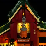 Close-up of illuminated upper barn window and bucket.