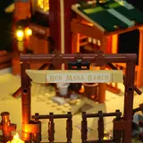 Close-up of illuminated 'Red Mesa Ranch' sign at night.