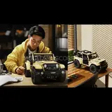 Man building, model on desk.
